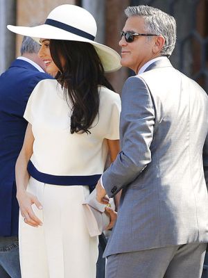 Amal in cream short-sleeved jacket with palazzo pants and a matching wide-brimmed hat.jpg